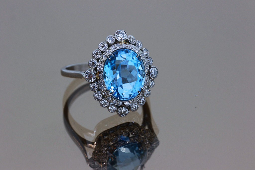 A blue topaz and diamond cluster ring