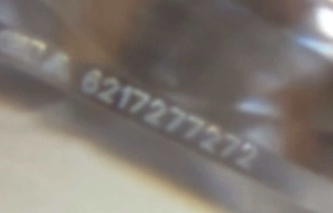 A GIA laser inscription on the girdle of a diamond, seen under magnification