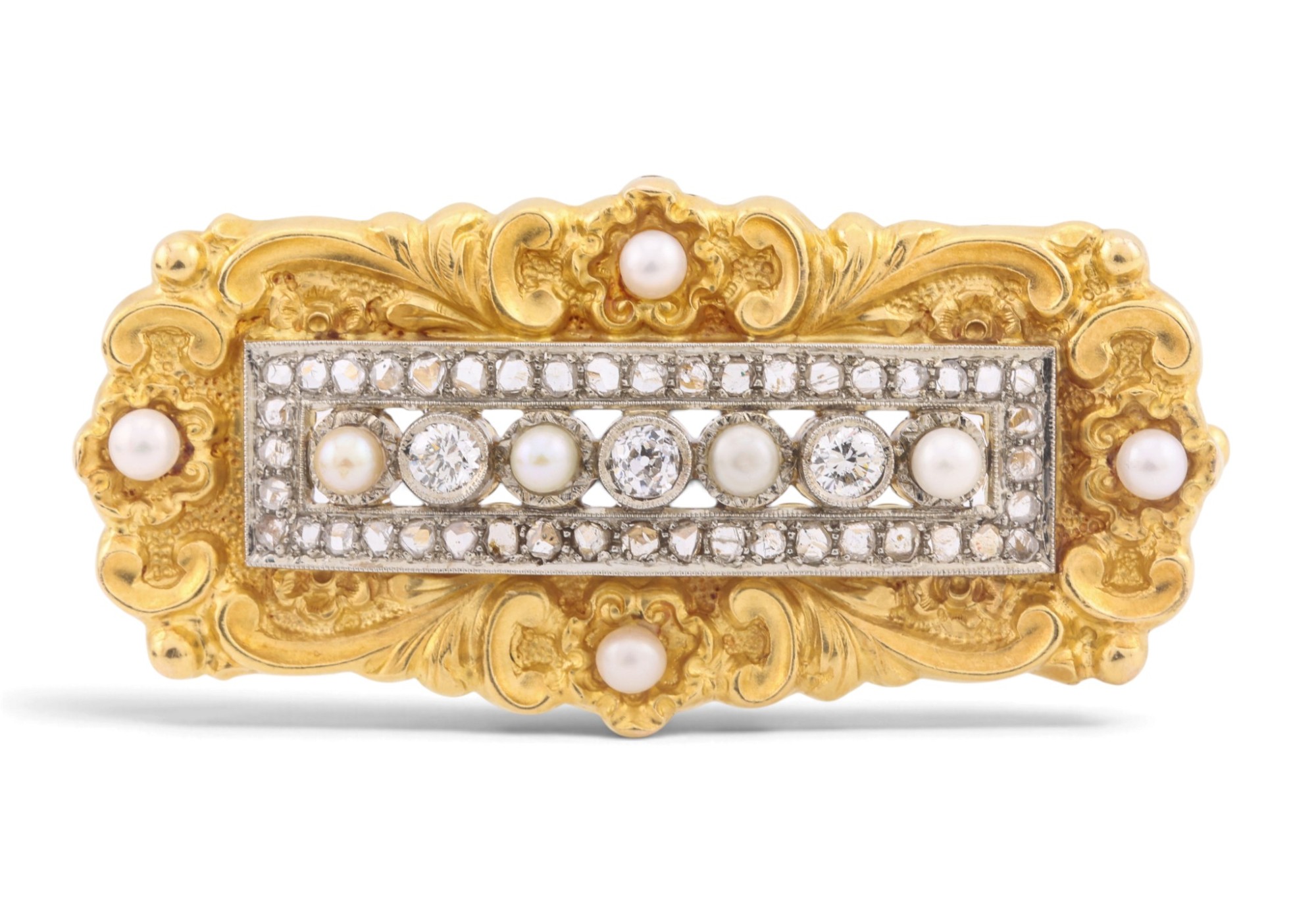 A chased gold plaque brooch set with pearls and diamonds, photographed on white