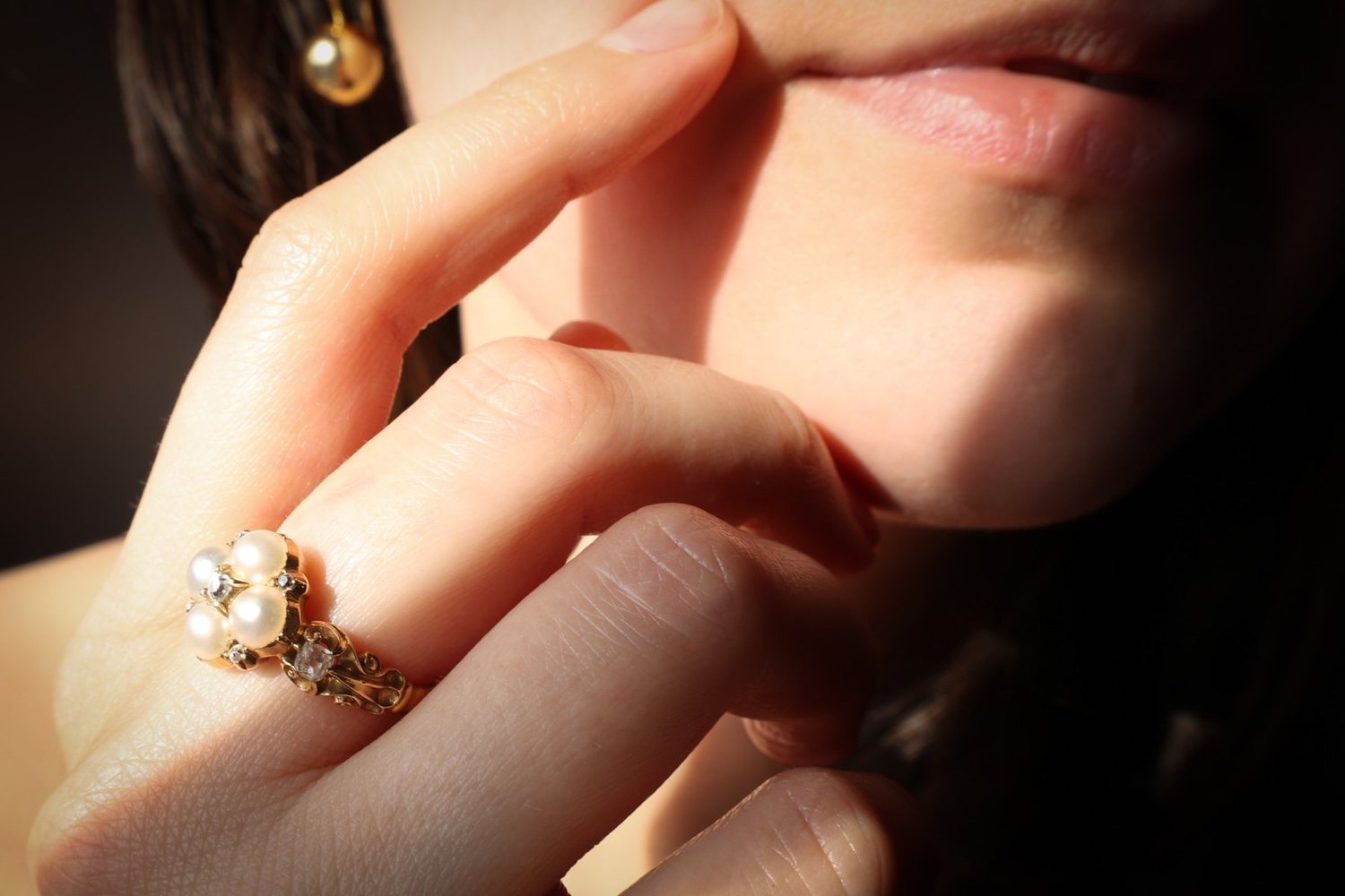 A pearl and diamond ring worn
