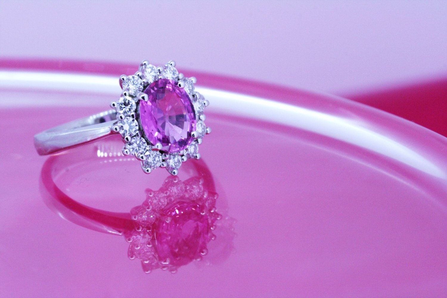 A pink sapphire and diamond cluster ring