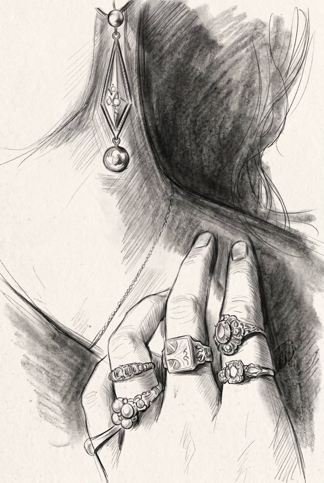 A hand wearing antique rings, with a drop earring and a fine chain