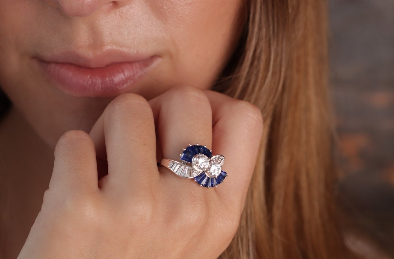 A sapphire and diamond ring worn