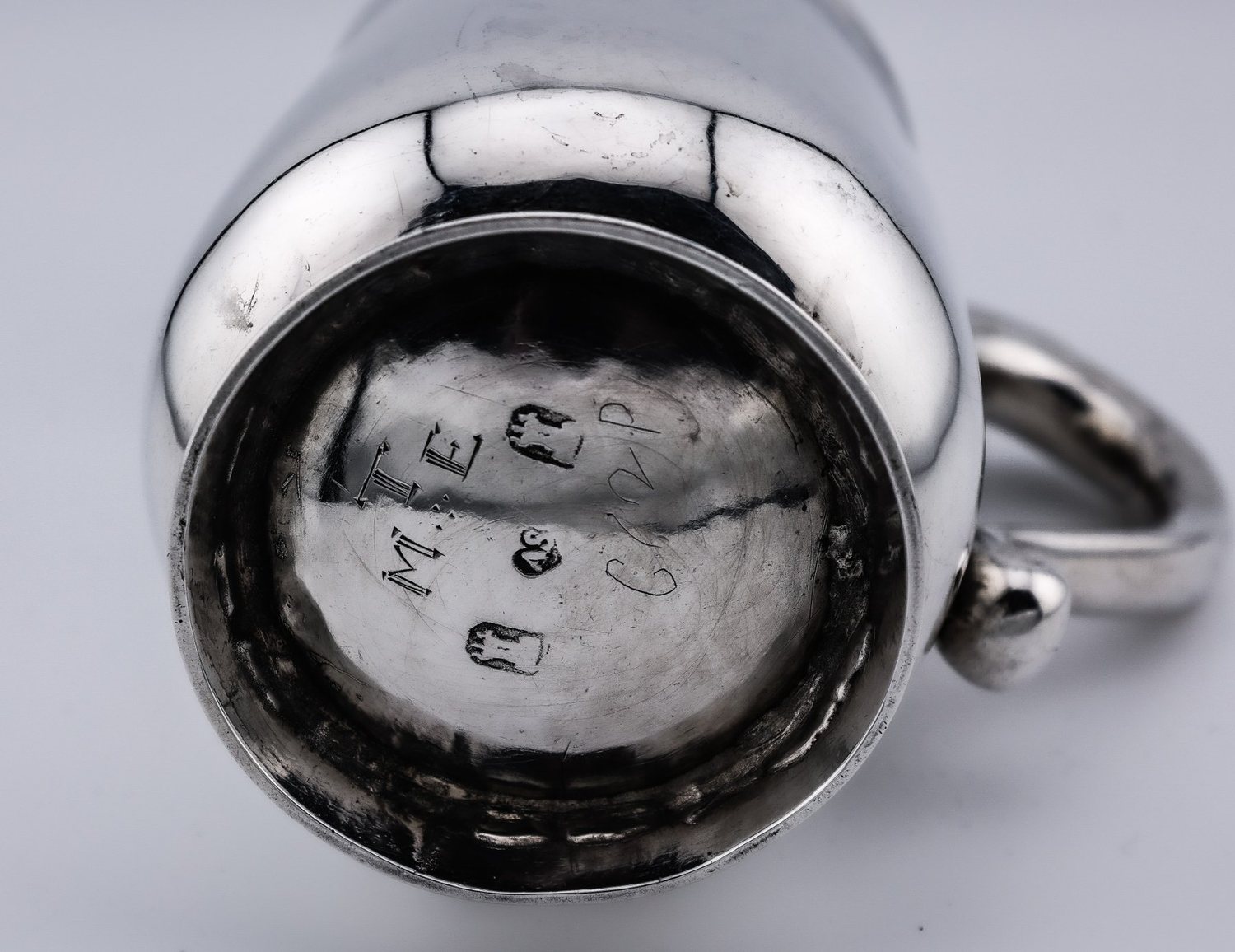 Maker's marks on the base of a silver cup