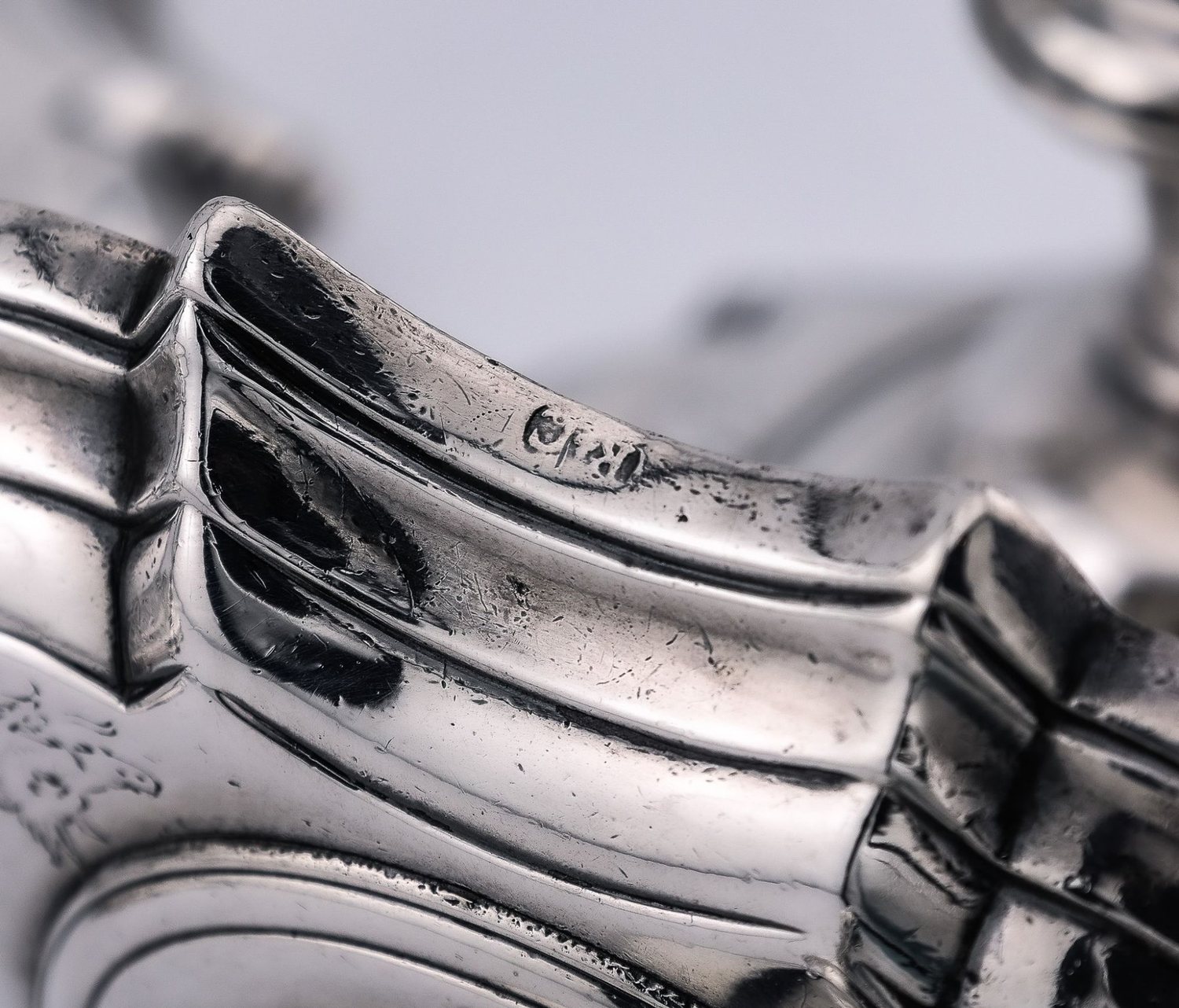 A mark struck on the shaped edge of a silver piece