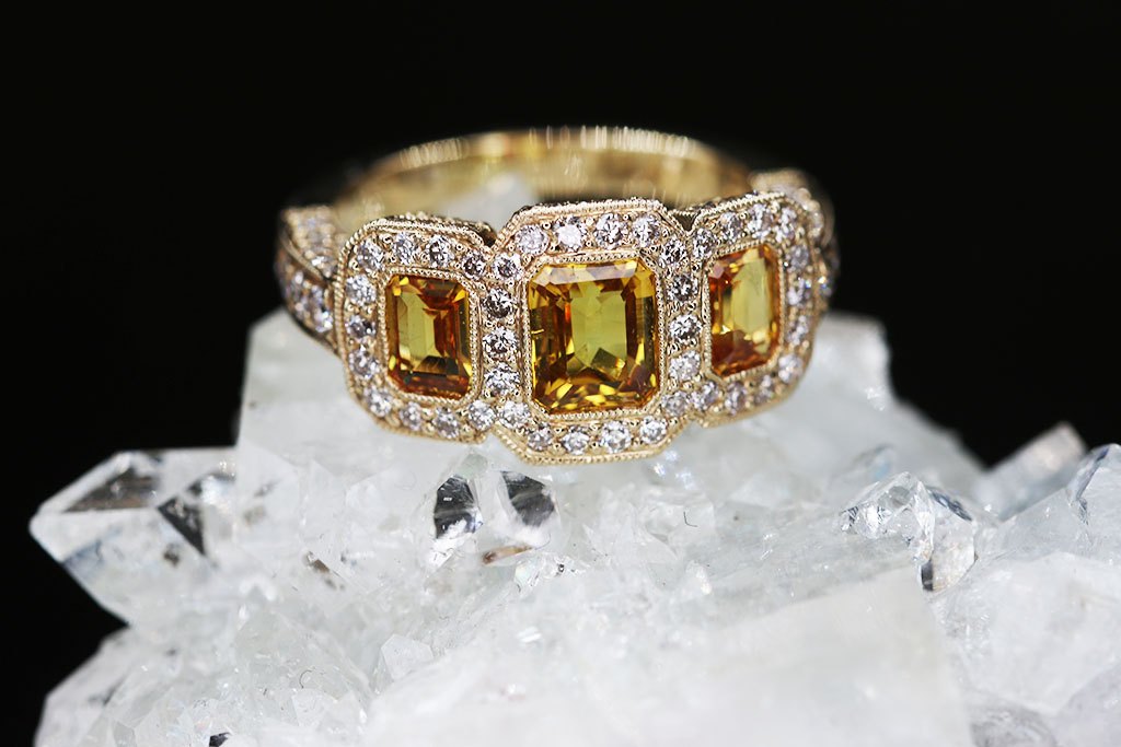 A yellow sapphire and diamond ring on a quartz crystal